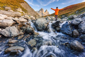 Landscape of iconic three peak and waterfall flowing of Aiguilles dArves in French alps at Savoie,...