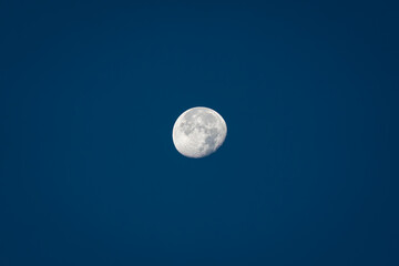 Naklejka na ściany i meble Moon during daytime against clear blue sky