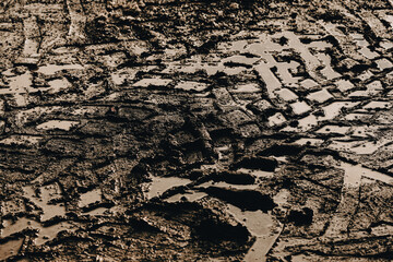 dark muddy road background with tire traces, dirty ground