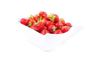 Fresh red strawberries in a white bowl