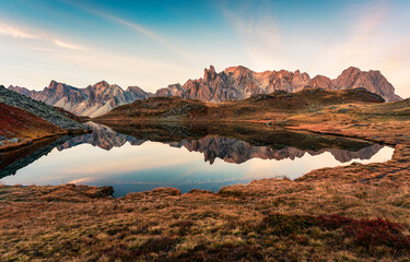 Sunrise over Lac Long with Massif des cerces reflection on the lake in Claree valley at French Alps, France