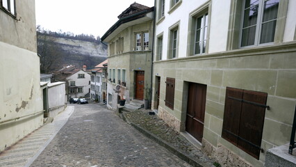 Fototapeta na wymiar Empty traditional European street with nobody. Cobblestone sidewalk with ancient buildings