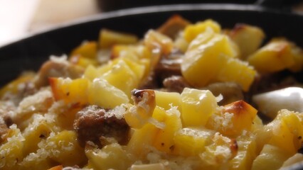 Pull back shot of Hot Baked Potato and Meat Skillet with Grated Cheese.