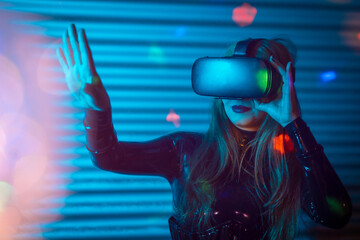 Young woman using virtual reality simulator headset