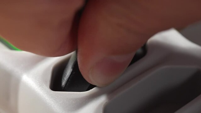 Inserting Plug into Surge Protector. Close-up, shallow dof.