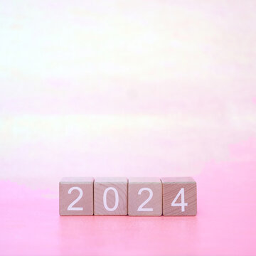 2024 wooden blocks on pink background