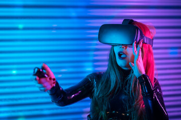 Surprised woman playing using Virtual reality goggles