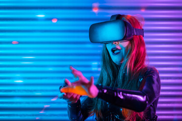 Surprised woman wearing VR goggles in a colorful space