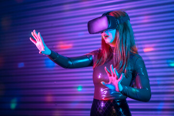 Blonde woman gesturing while wearing VR goggles