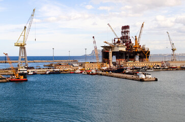 Panoramic landscape view of semi-submersible drilling vessel in dock of Palermo port. Vessel under renovation
