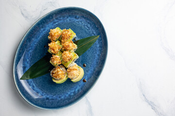 Japanese cuisine. Rolls with avocado, eel, and fried cheese