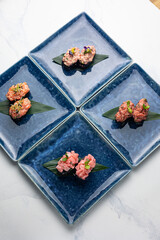 Japanese cuisine. Gunkan on blue plates
