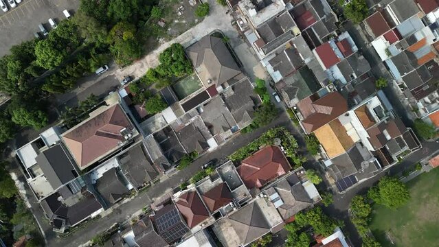 Aerial view of Solo City with buildings, crowded vehicles traffic in morning sunlight. Surakarta cityscape urban landscape. Population density is displacing agricultural land and forests.