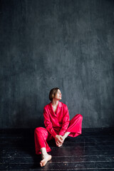 Beautiful woman in red silk pajamas