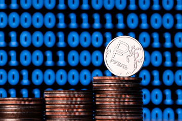 Conceptual story about digital ruble - coin with Russian ruble symbol and binary code