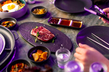 close-up top view delicious appetizing juicy piece of raw meat on table with sauces on appetizers...