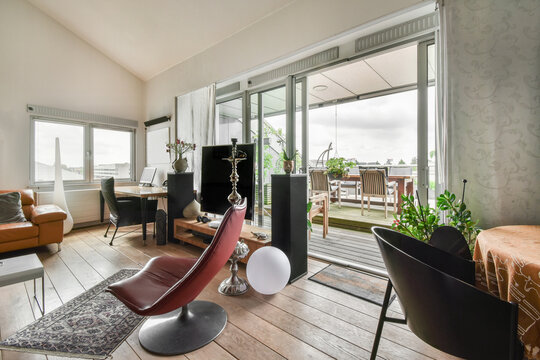 Living room with furniture and television adjacent to terrace