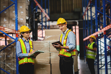 Caucasian manager working in warehouse logistics Professional workers work in the warehouse. Check stock with digital tablets in logistics centers.