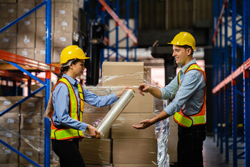 Workers wrap boxes with stretch film at a warehouse. warehouse Logistics and export concept.