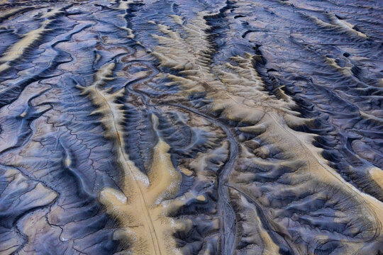 Aerial perspective of river deltas and sediment patterns