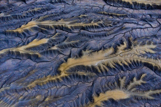 Aerial view of blue ridges in a barren desert landscape