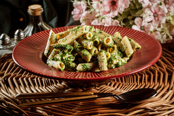 Penne pasta with spinach and chicken.
