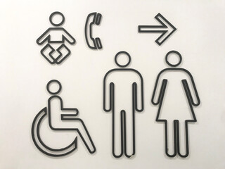 Men and women signs for restroom on modern stone wall background. Toilet sign concept.