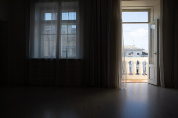 Interior of an empty dark room with windows