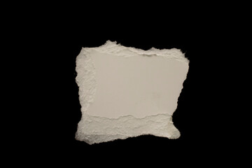 edge of a torn white sheet of paper on a black background, black hole