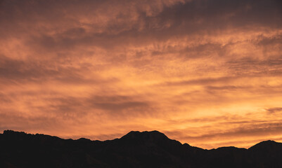 Obraz premium Pink and Yellow Light Brightens Wafting Clouds