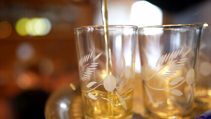 Serving Ritual - Pouring Fresh Tea into Glass Cup at Restaurant