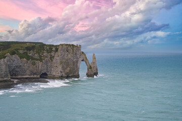 Etretat in Normandy, the famous cliffs and needle on the pebble beach

