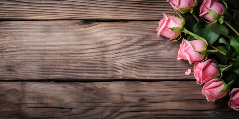 Pink roses on wooden planks as table, space for text