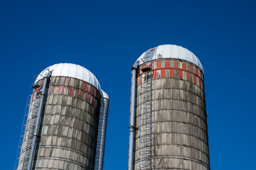 Two farm silos on a blue sky