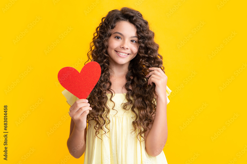 Wall mural happy teenager portrait. cheerful lovely romantic teen girl hold red heart symbol of love for valent