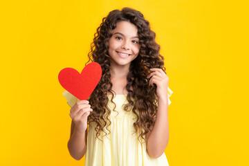 Happy teenager portrait. Cheerful lovely romantic teen girl hold red heart symbol of love for...