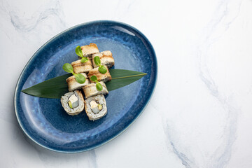 Japanese cuisine. Handmade sushi rolls with eel