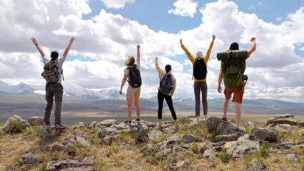 Five hikers group achieve success and raise arms standing on high mountain peak at scenic views. Travel active recreation, motivation to trekking sport and top
