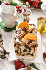 Homemade poppy seed cake with icing for Christmas on festive table in bright colors