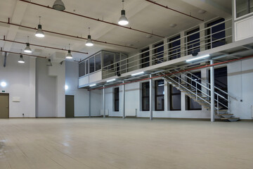 Interior of a large illuminated industrial space with mezzanine