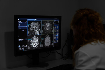A doctor radiologist in a hospital mri ct magnetic resonance imageing analysis room reading X-rays...