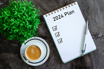 Note book with 2024 goals text on it to apply new year resolutions and plan.	