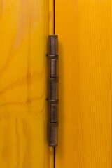Yellow color door hinge metal object door detail element part close-up macro