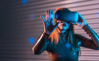 Woman submerged in metaverse reality by using VR glasses