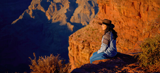 Native American girl is fascinated by the breathtaking beauty of the Grand Canyon - travel...
