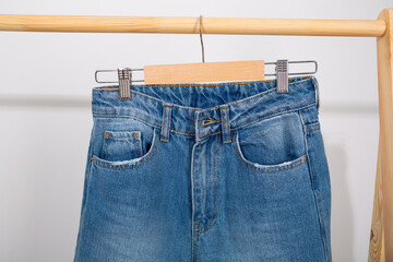 Blue denim pants on a hanger conscious consumption