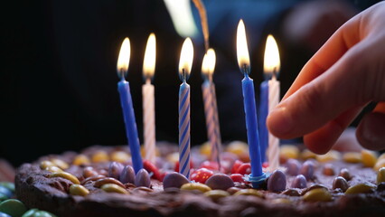 Birthday candles flames on top of cake during child's party celebration