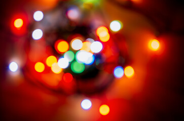 Blurred out-of-focus bright lights of a garland on a dark background close-up