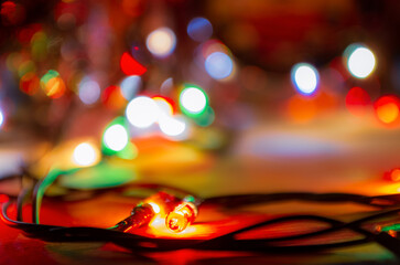 Blurred out-of-focus bright lights of a garland on a dark background close-up