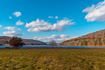 Quaker lake NY, mountain valley landscape late fall weather, sunny windy day